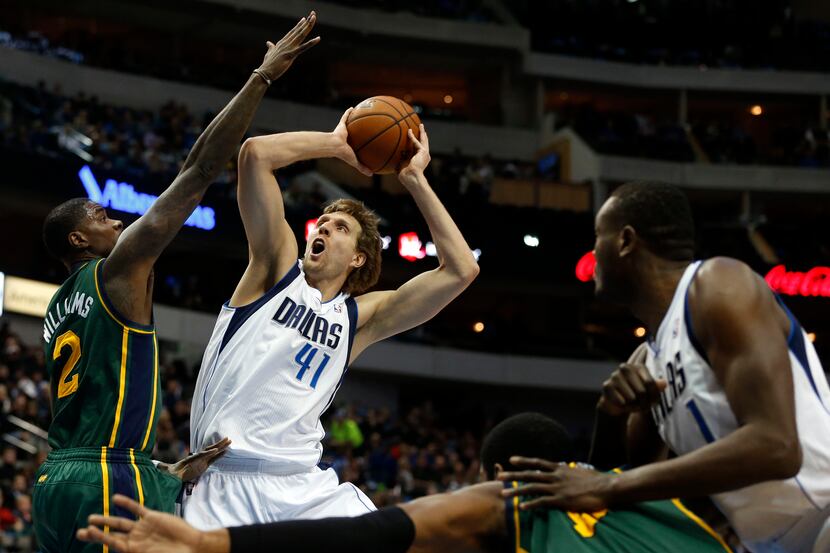Dallas' Dirk Nowitzki shoots over Utah's Marvin Williams during the Mavericks' win over the...