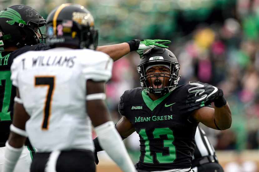 North Texas Mean Green running back DeAndre Torrey (13) taunts Southern Miss defensive back...