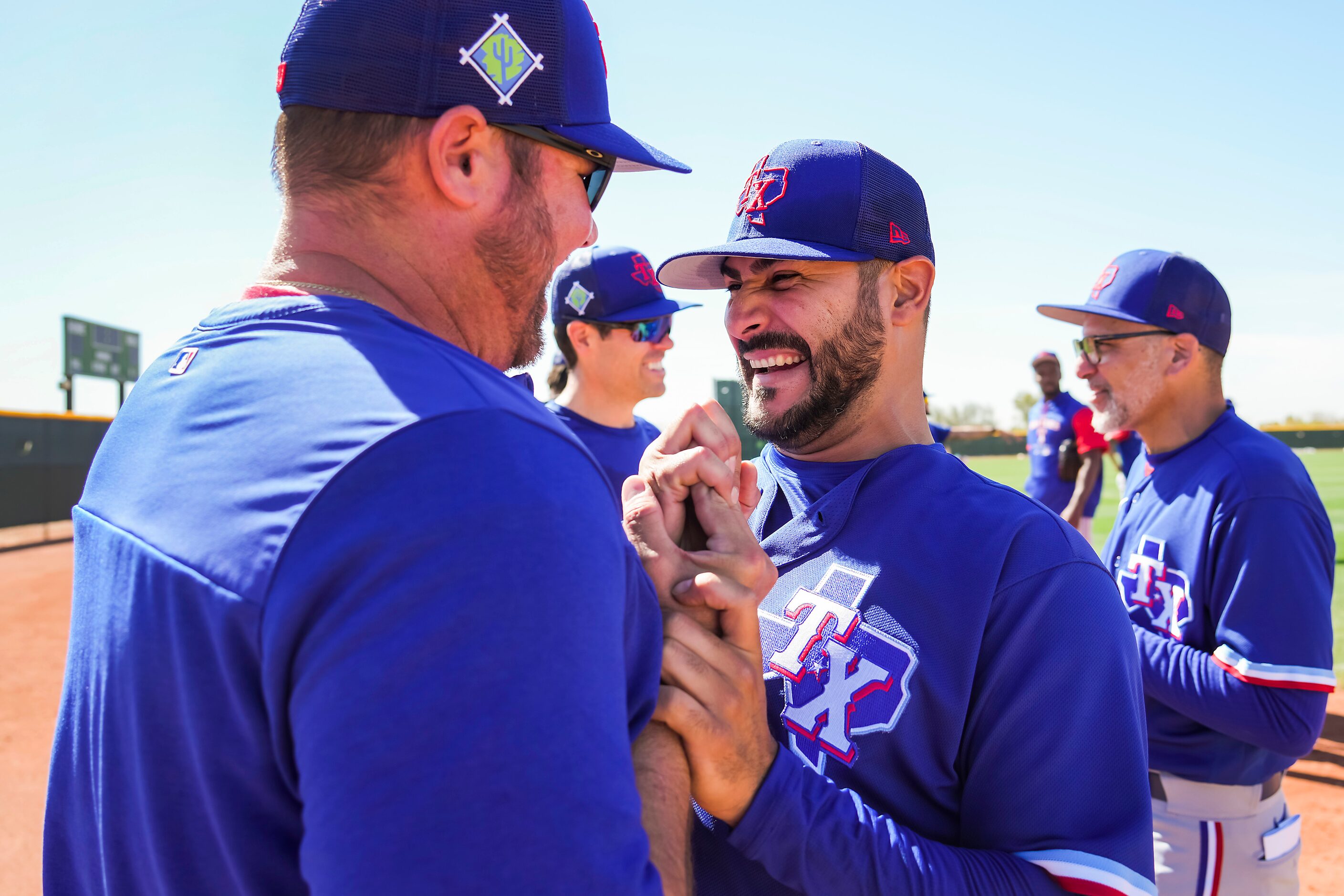 Texas Rangers pitcher Martin Perez (center) laughs with Special Assistant to the General...