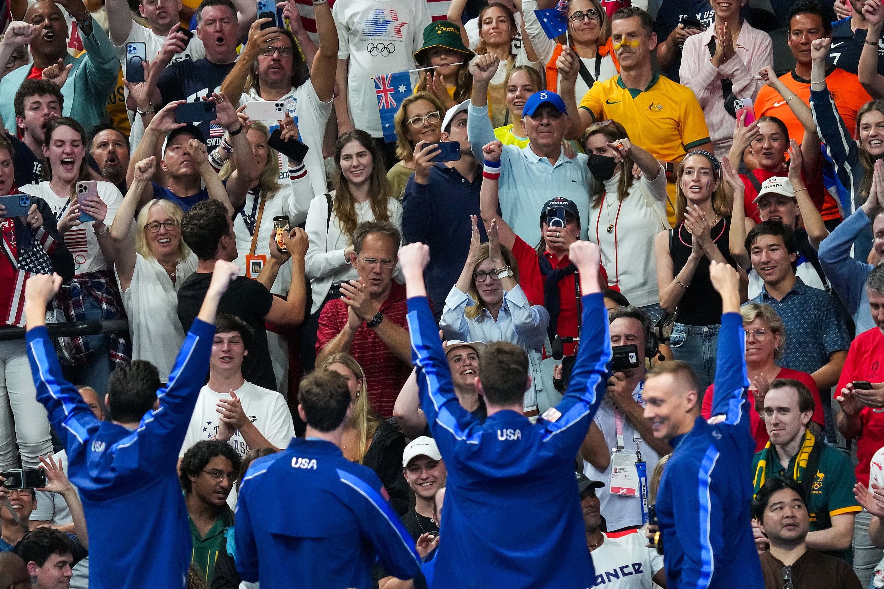 The crowd cheers members of the United States men's gold medal winning 4x100-meter freestyle...