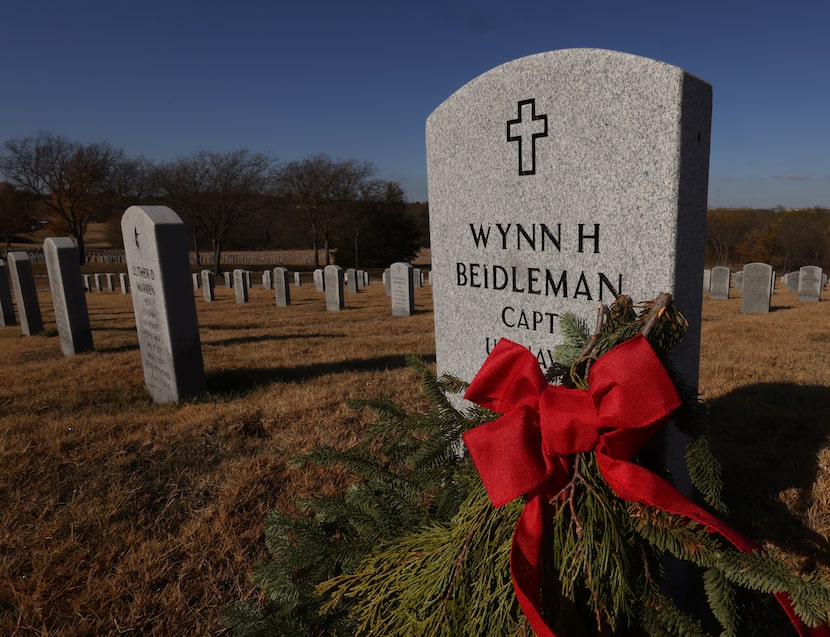 A freshly laid wreath adorns the headstone at the grave of US Navy Captain Wynn H....