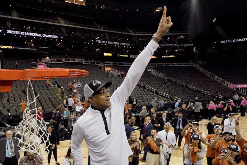 Interim Texas head coach Rodney Terry cuts the net after Texas won the Big 12 Conference...