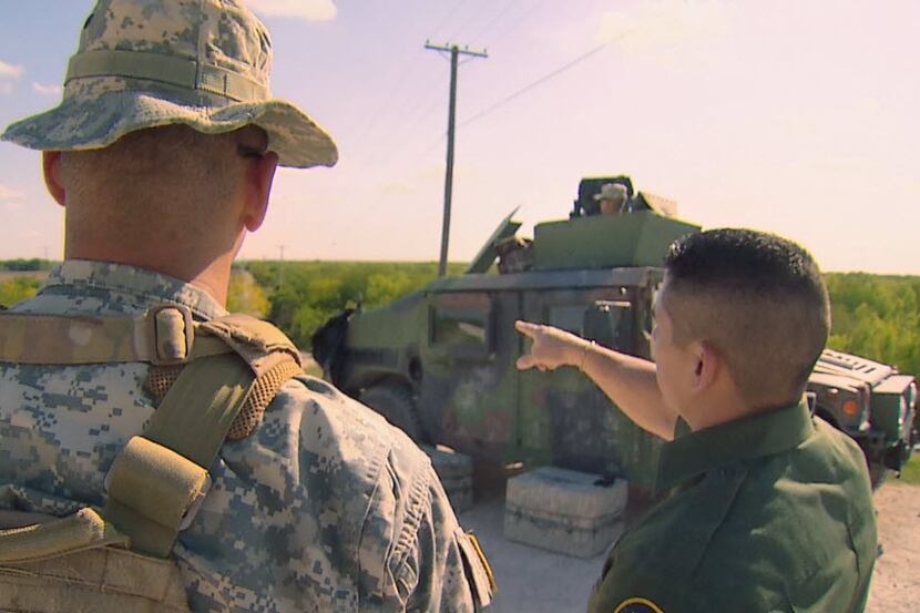 Members of the Texas National Guard (left) and U.S. Border Patrol (right) near the...