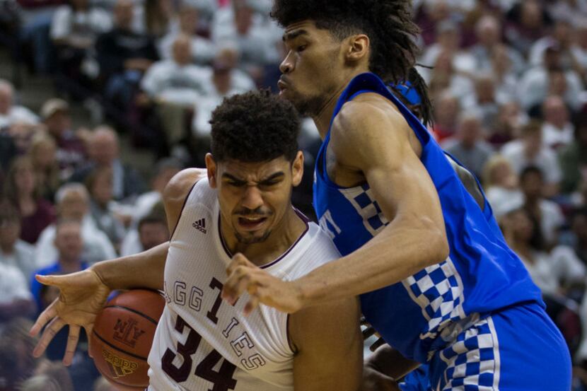 Kentucky forward Nick Richards (4) fouls Texas A&M center Tyler Davis (34) as his drives the...