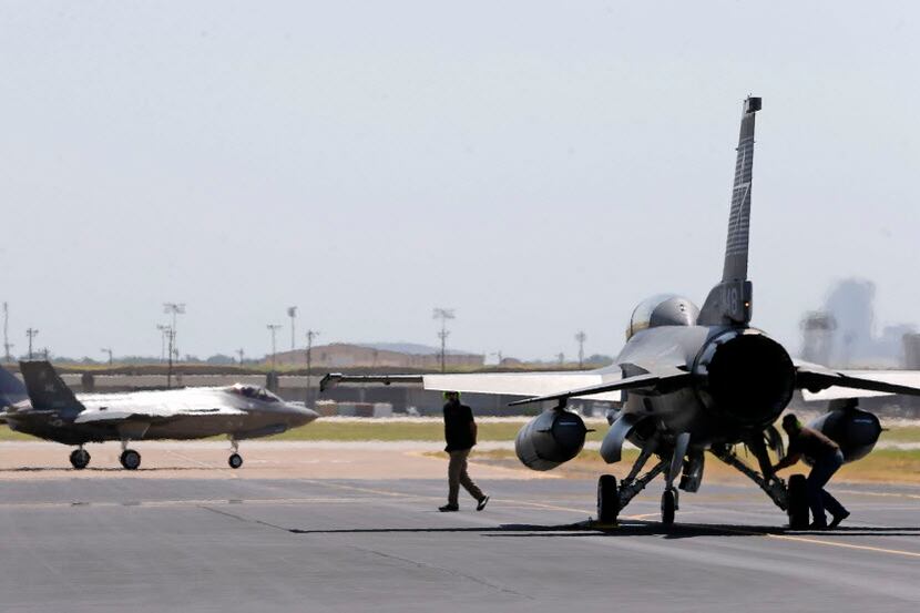 
A crew prepares an F-16 to escort an F-35 for a test flight at Lockheed Martin  in Fort...