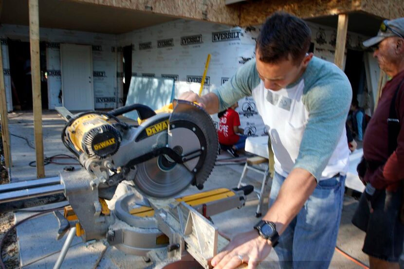 
Chad Sprong trims pieces of wood for the Habitat home in Celina. 
