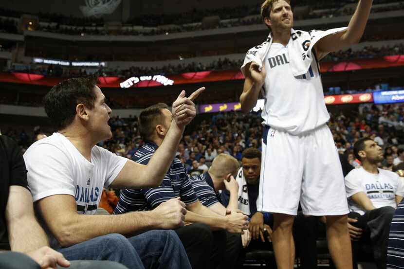 Dallas Mavericks owner Mark Cuban talks to Dallas Mavericks forward Dirk Nowitzki (41)...