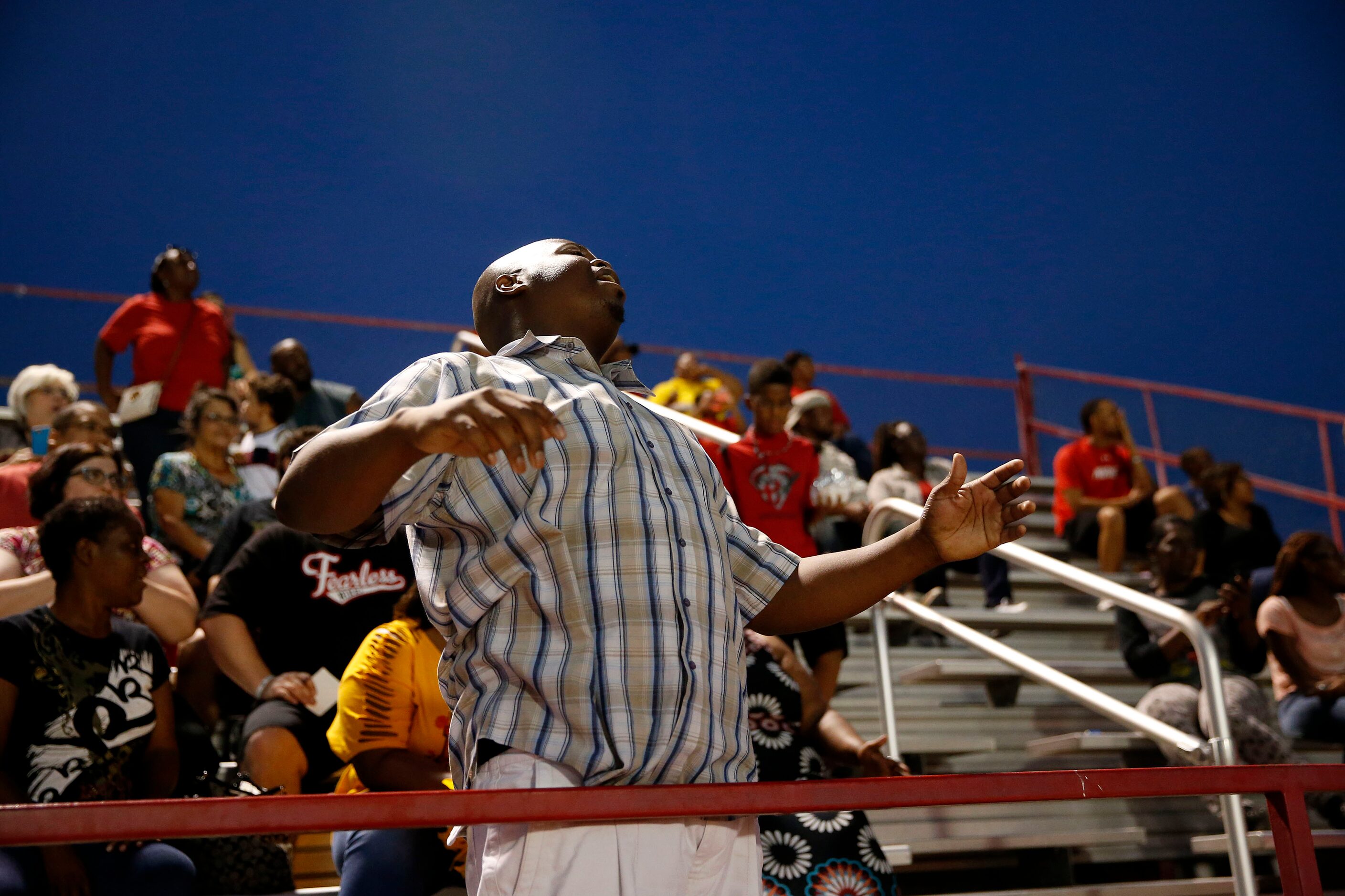 AAA Prime U fan John Gray reacts to a play in the first half during a high school football...