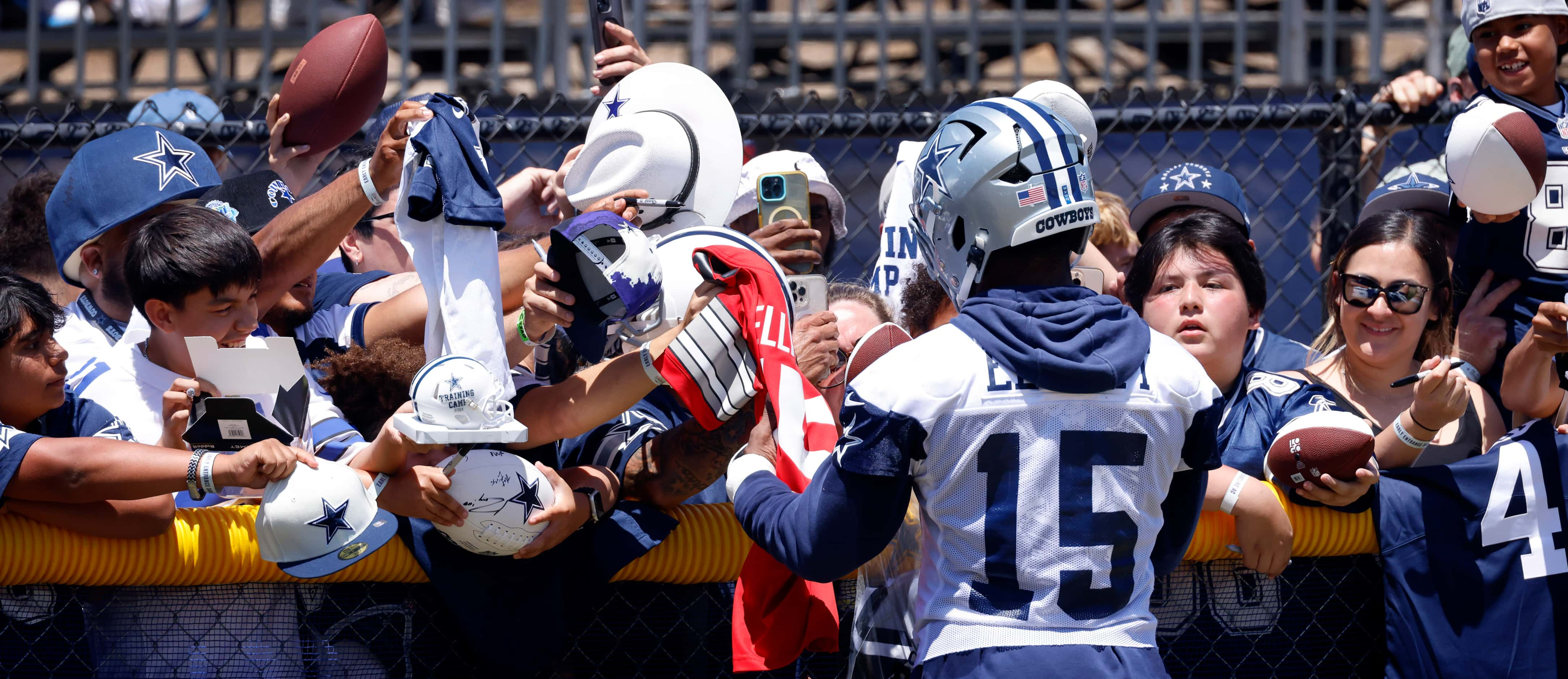 Dallas Cowboys running back Ezekiel Elliott (15) signs autographs for fans following...