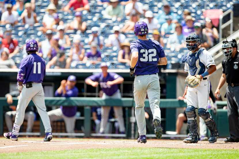 TCU base runner Cole Fontenelle (32) scores a run in the second inning against Oral Roberts...