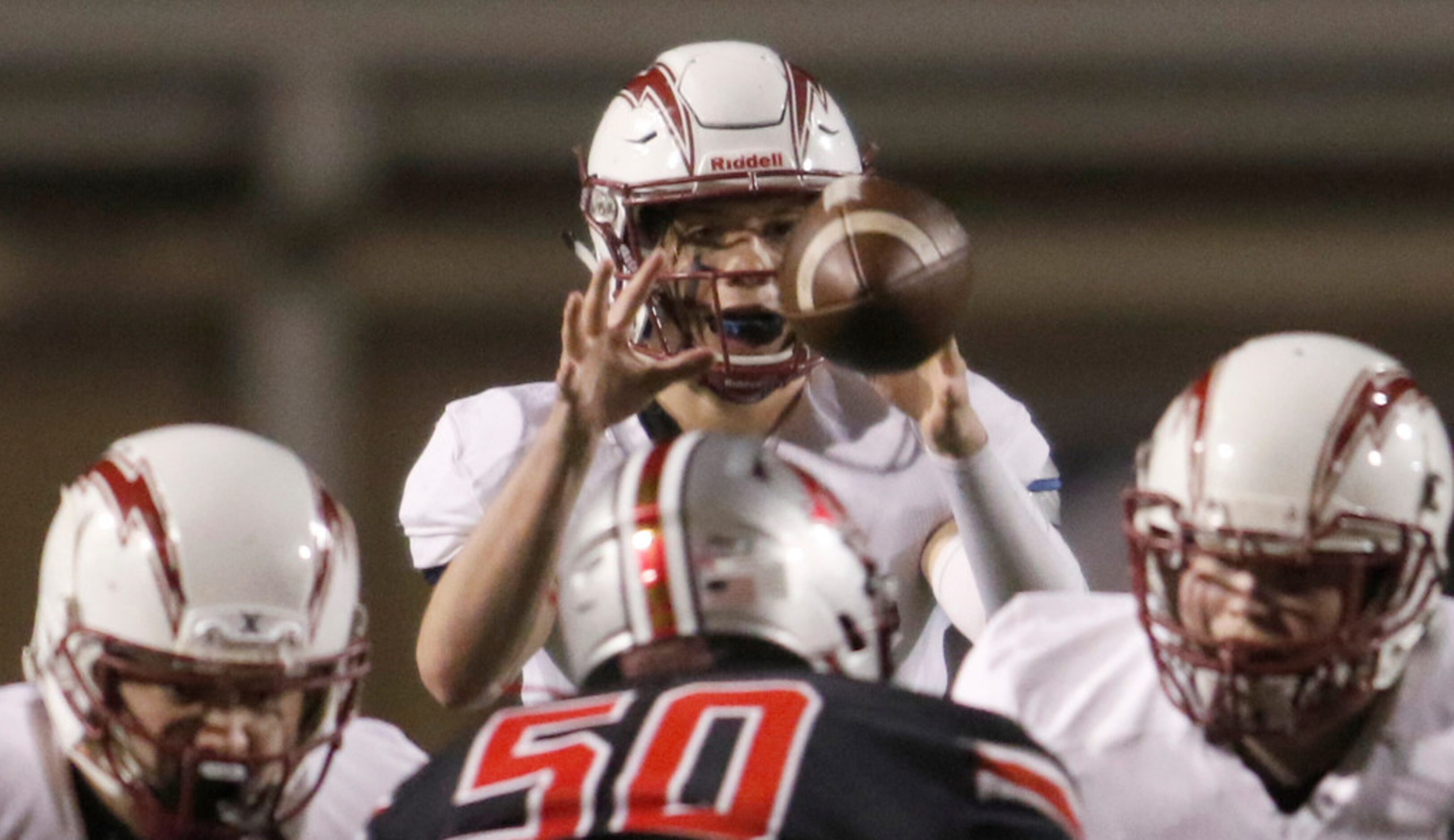 Keller Central quarterback Landon walker (7) eyes a snap from center during 2nd quarter...