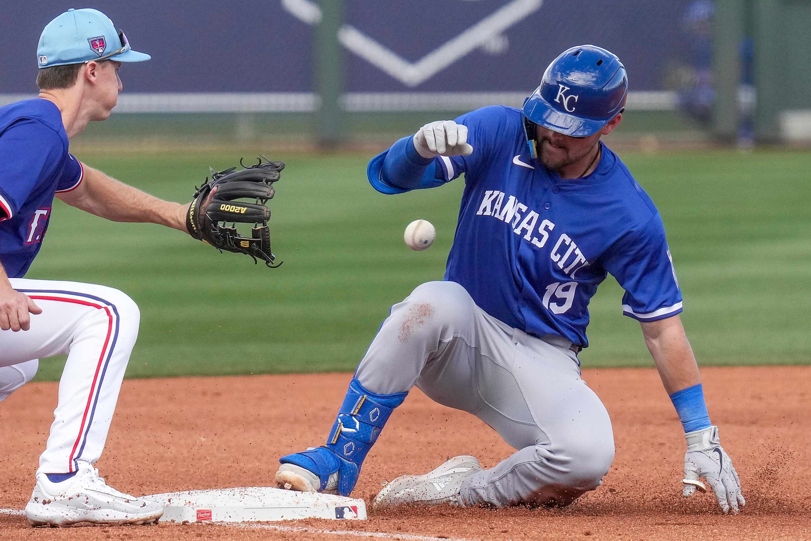 Kansas City Royals second baseman Michael Massey is safe with a triple ahead of the throw to...