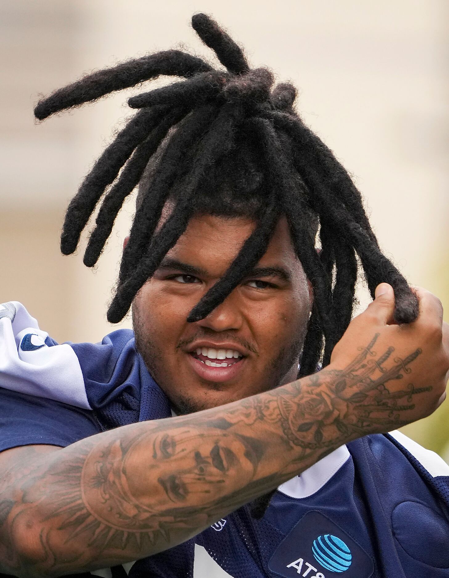 Dallas Cowboys defensive tackle Trysten Hill adjusts his hair as he takes the field for a...