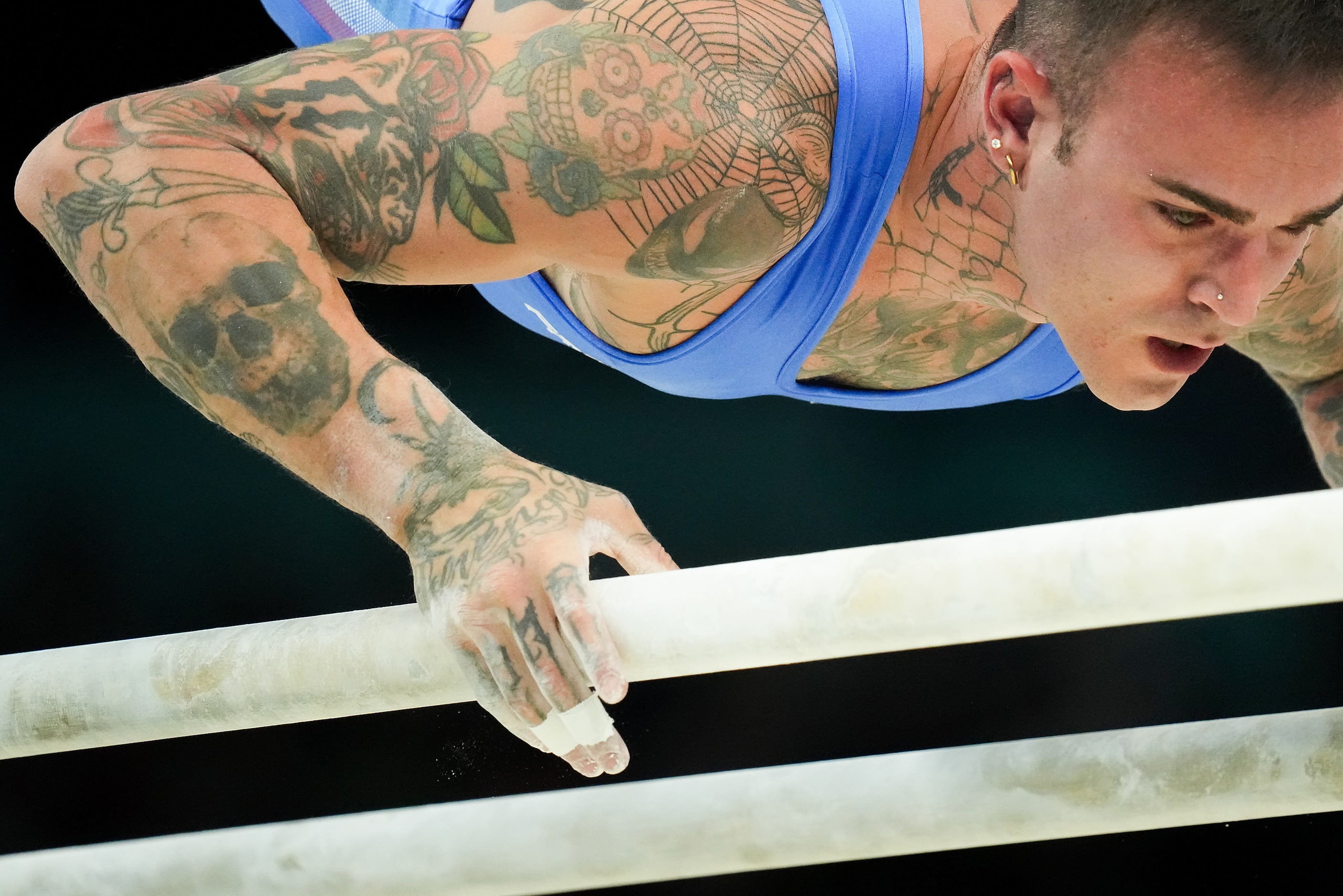 Nicola Bartolini of Italy competes on the parallel bars during the men’s gymnastics team...