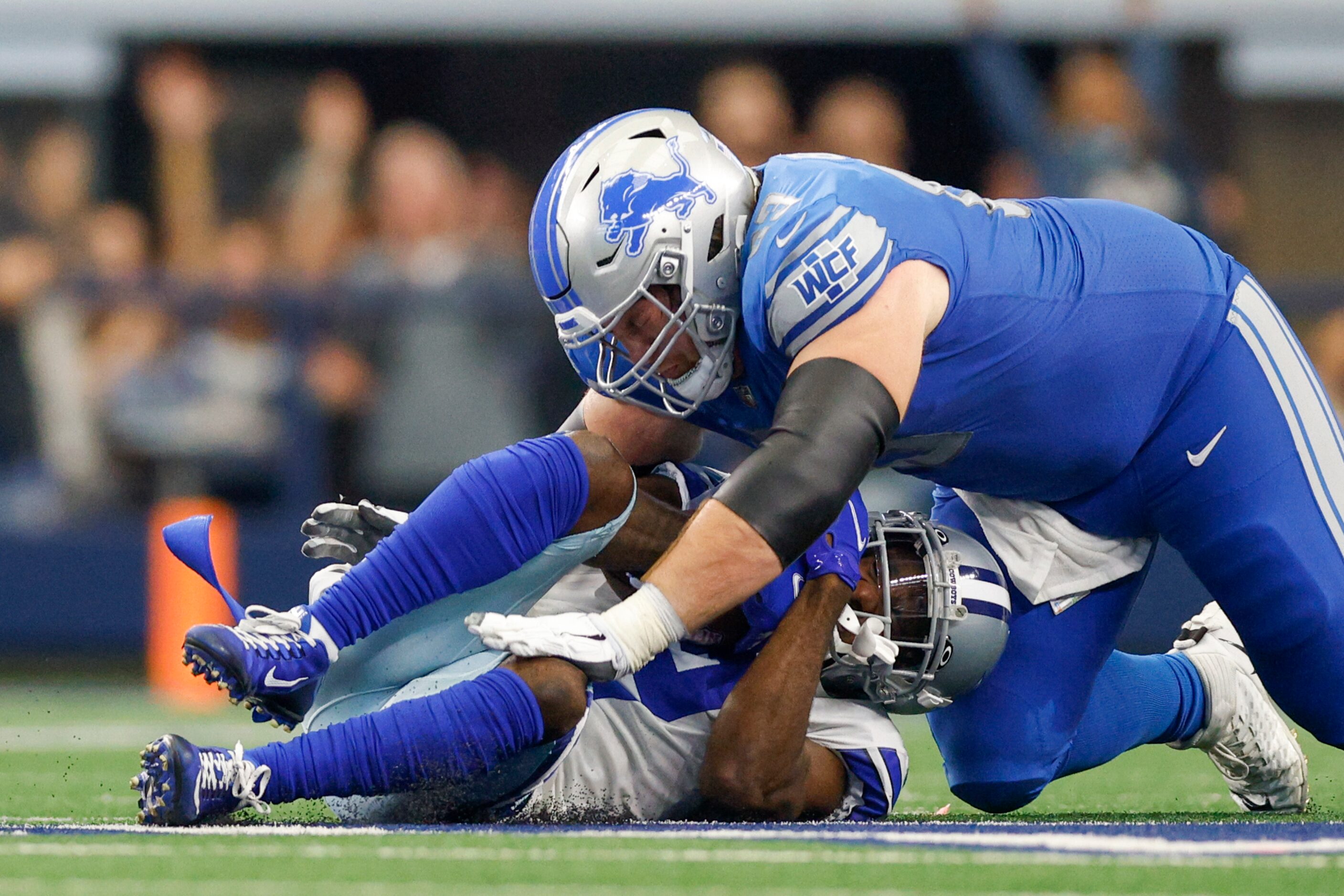 Detroit Lions center Evan Brown (63) lands on Dallas Cowboys cornerback Jourdan Lewis (2)...