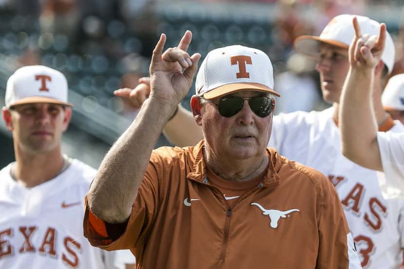 Texas coach Augie Garrido sings "The Eyes of Texas" with the team after Texas defeated...