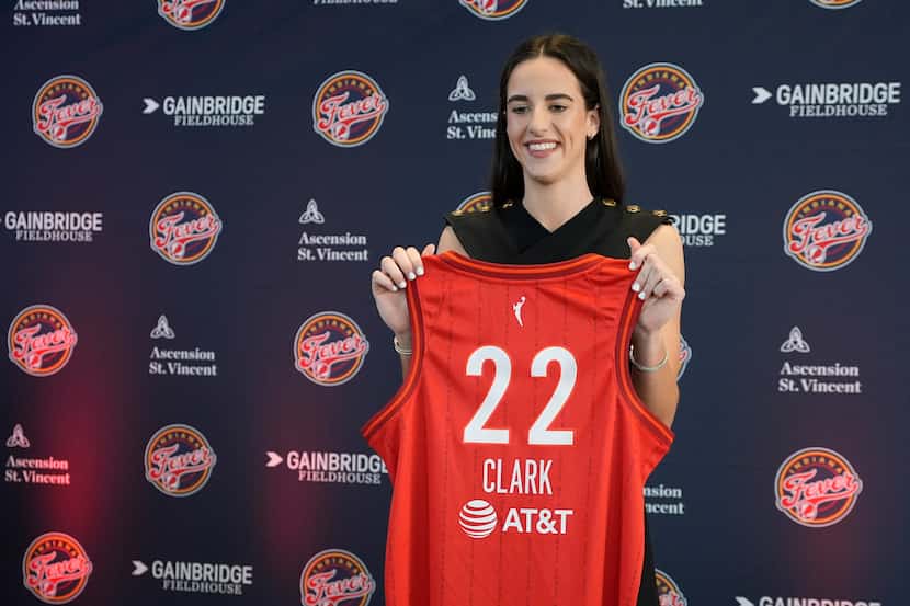 Indiana Fever's Caitlin Clark holds her jersey following a WNBA basketball news conference,...