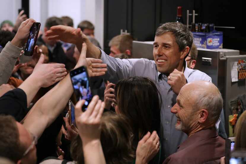 Democratic presidential candidate Beto O'Rourke shakes hands as he arrives at a packed St....