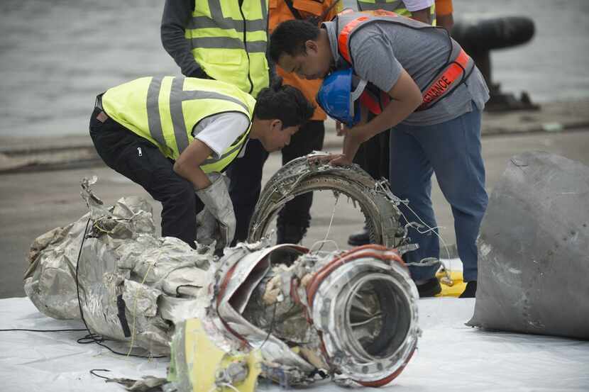 Investigators examine engine parts from the ill-fated Lion Air flight JT 610 at a port in...