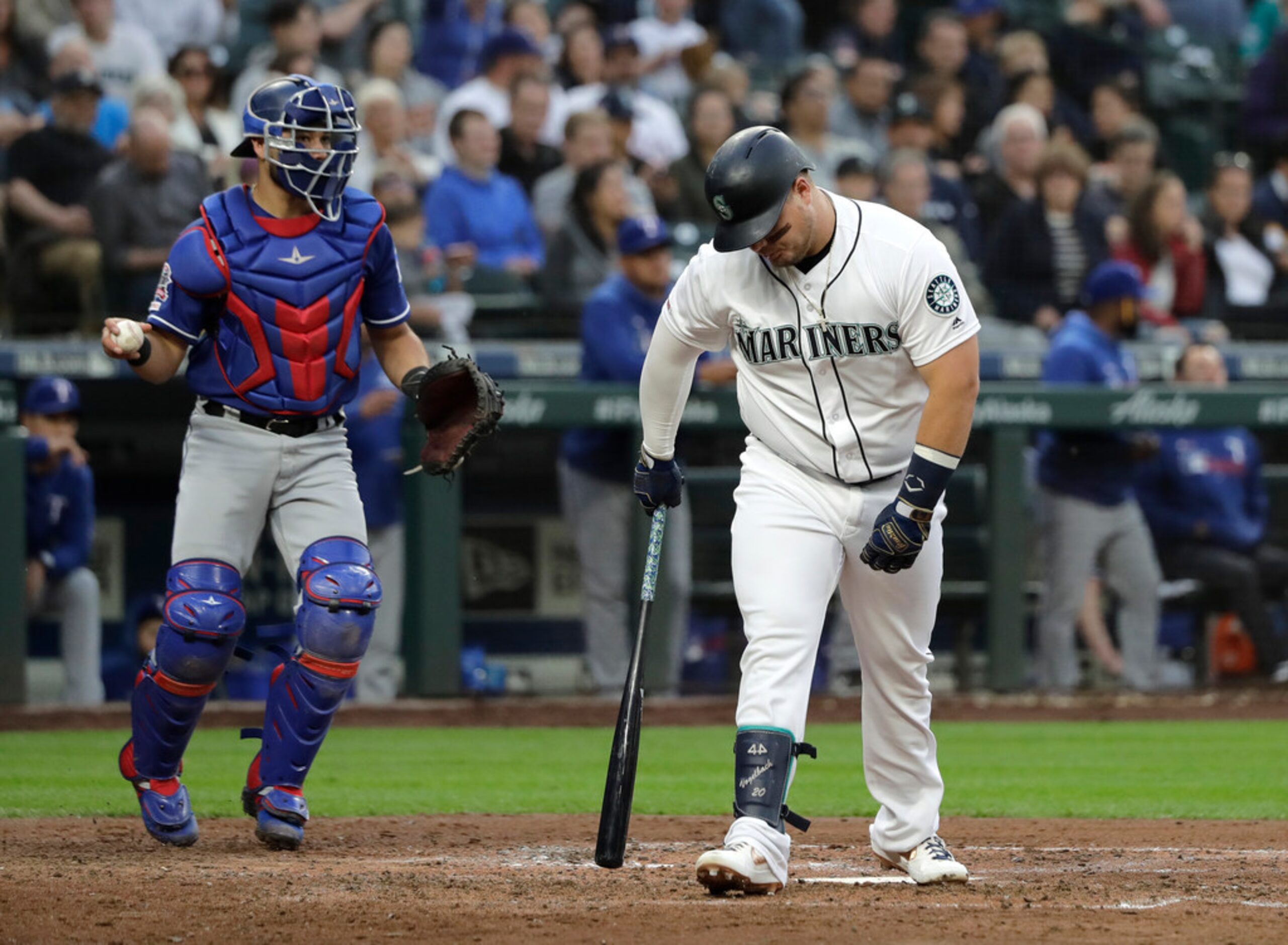 Seattle Mariners' Daniel Vogelbach walks away from the plate as Texas Rangers catcher Isiah...