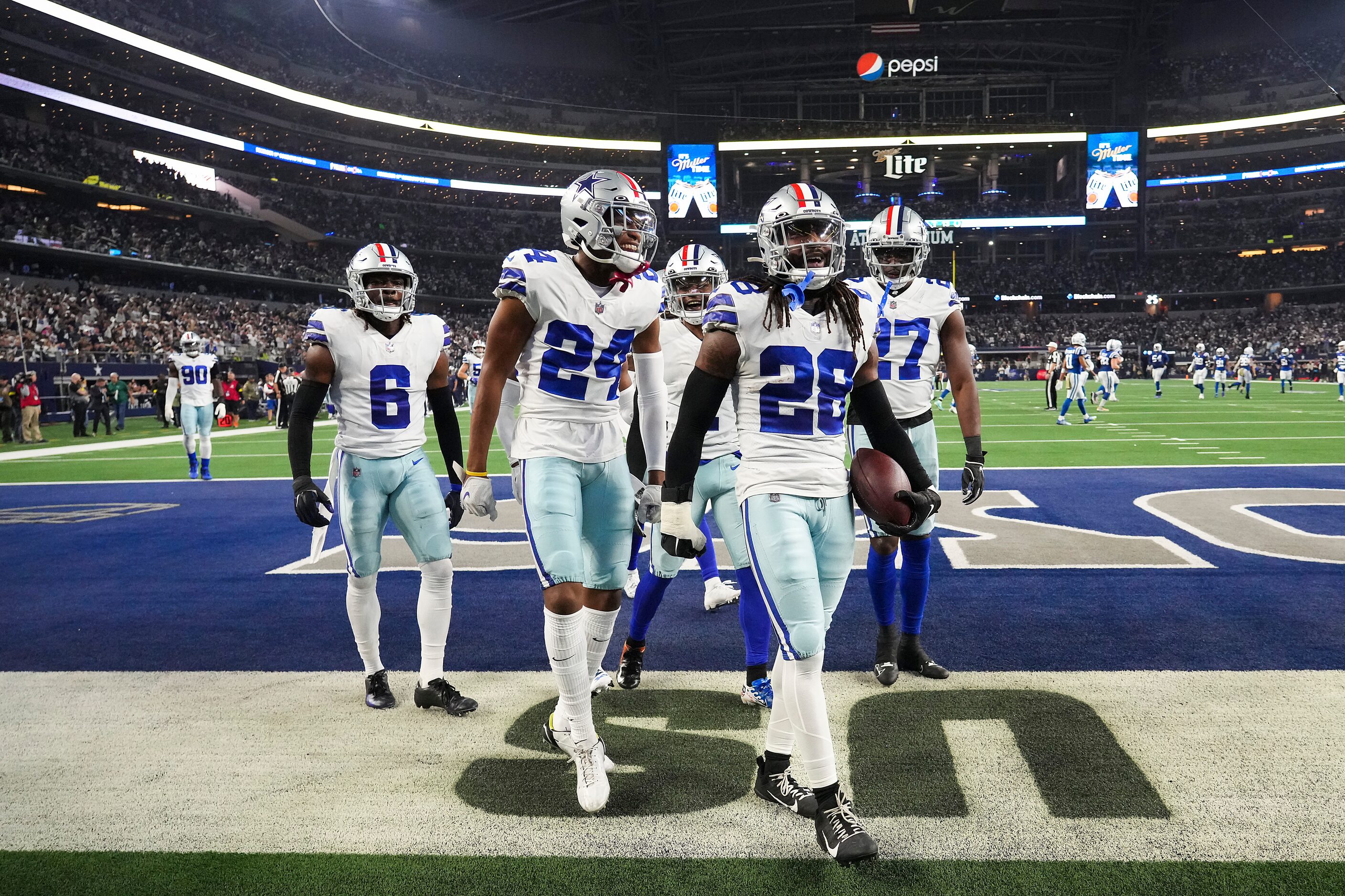 Dallas Cowboys safety Malik Hooker (28) celebrates with teammates after intercepting a pass...