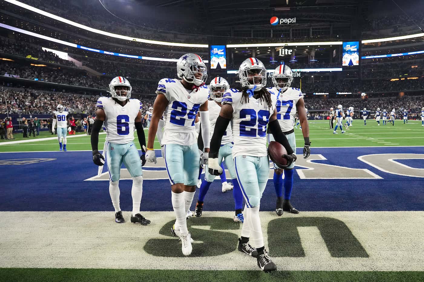Dallas Cowboys safety Malik Hooker (28) celebrates with teammates after intercepting a pass...