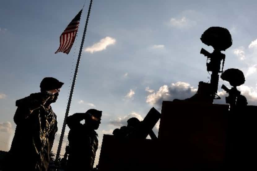 
Soldiers saluted their fallen friends after the memorial service for victims of the...