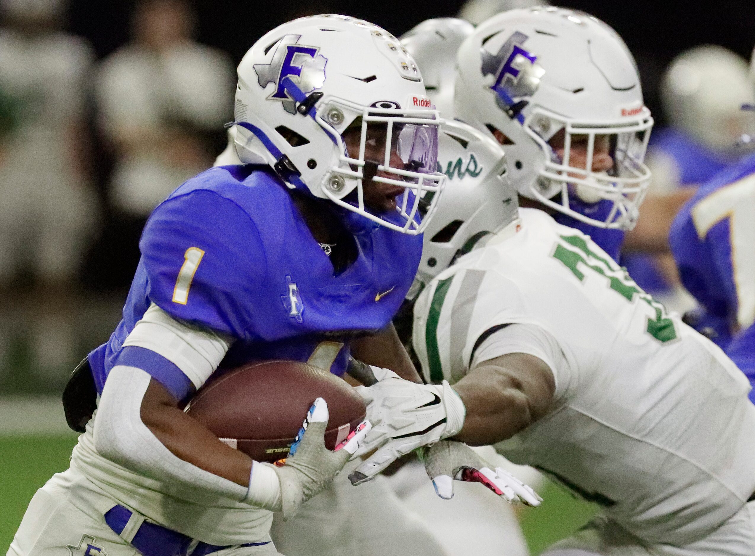 Frisco High School running back Kam Pendergraph (1) looks for room to run during the first...