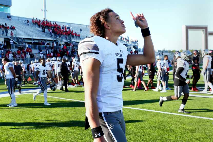 Guyer quarterback Eli Stower points to the sky in celebration after their 35-17 win against...