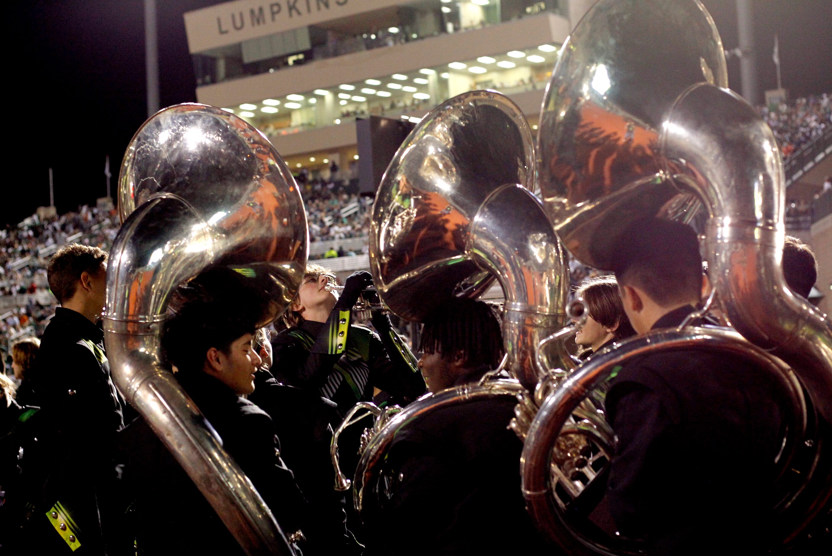 Members of the Waxahachie band's brass section assemble as they await their performance...