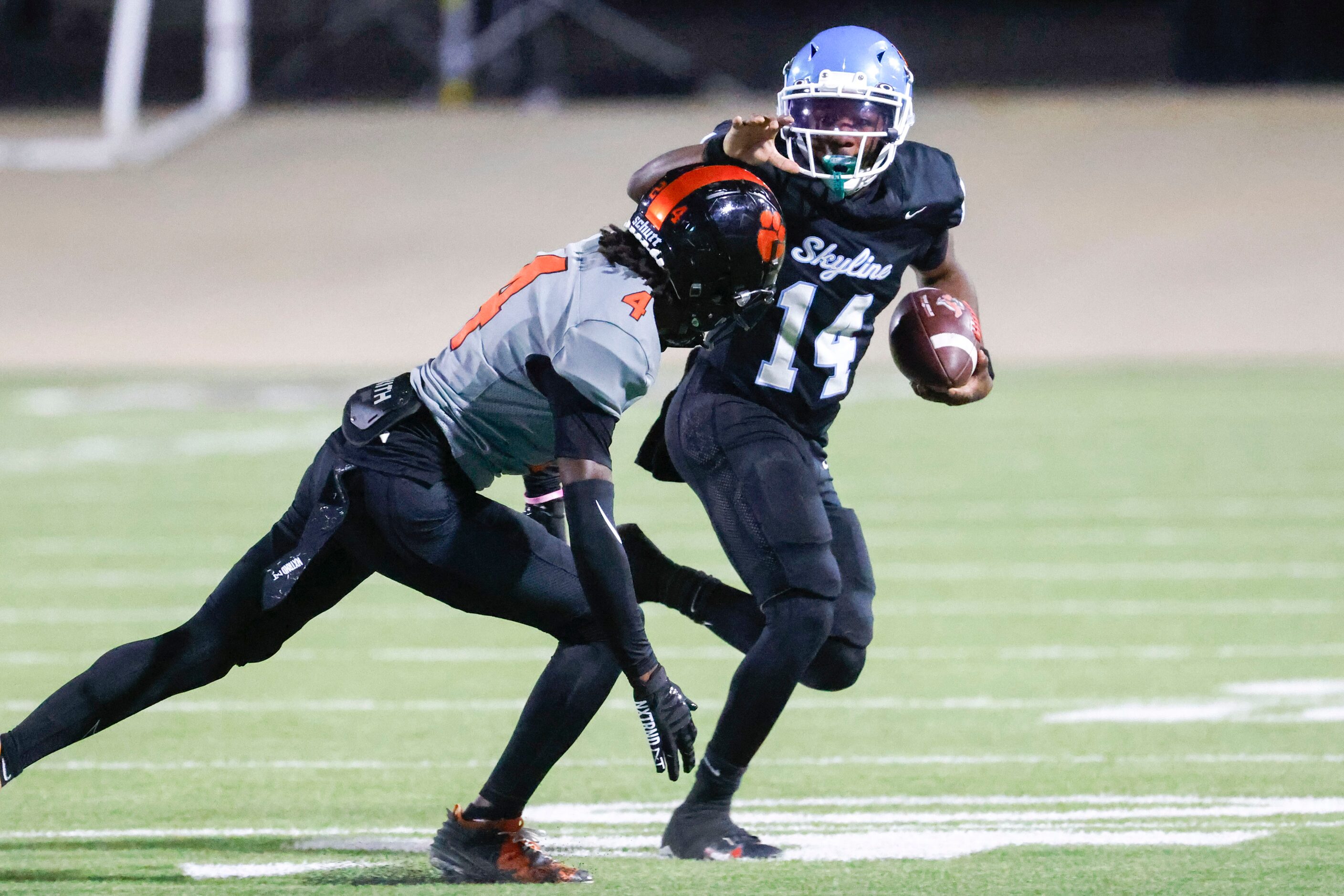 Skyline High’s Donte Ware (14) runs past Lancaster high’s Victor Lincoln during the first...