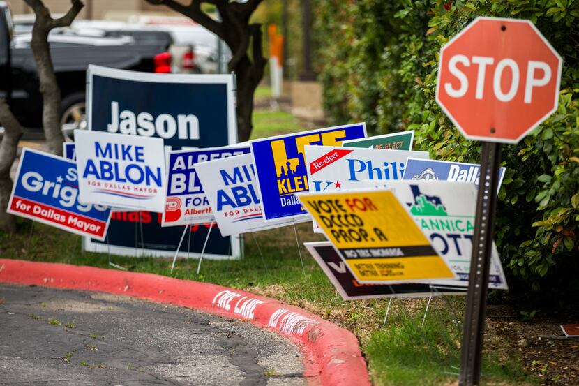 Campaign signs are displayed at the Dallas ISD Administration building, which is an early...
