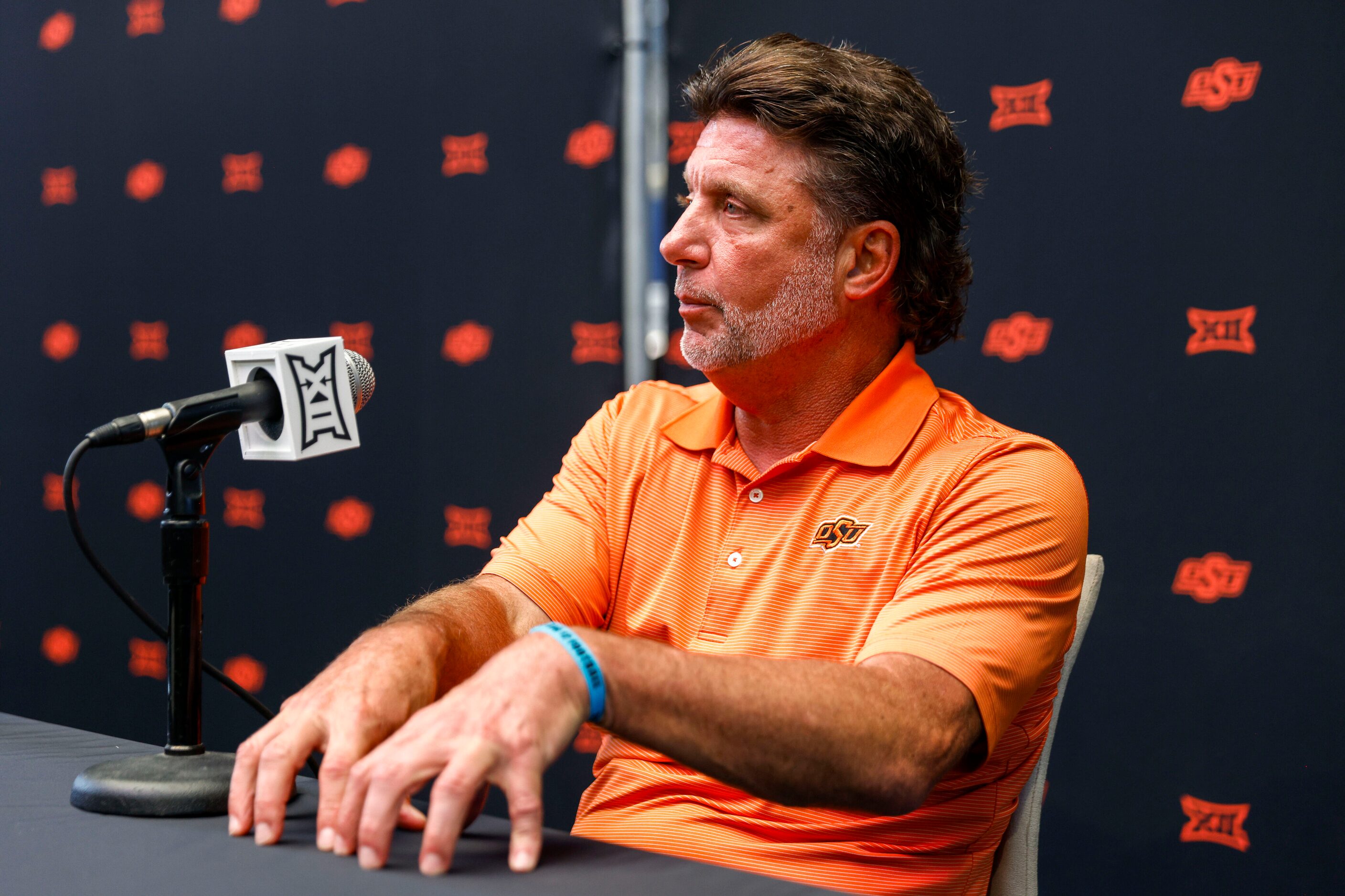 Oklahoma State head coach Mike Gundy speaks with reporters during the Big 12 Media Days at...