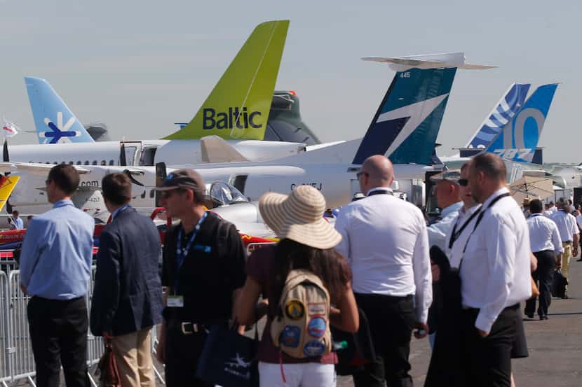 Visitors walk on the tarmac at Paris Air Show, in Le Bourget, east of Paris, France,...