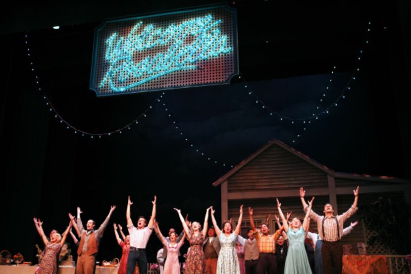 Joe, played by Doug Carpenter, and neighbors perform a large dance number during a...