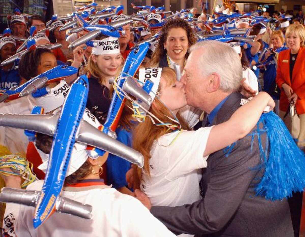 Southwest Airlines Chairman Herb Kelleher greets employees at a parade during a welcoming...