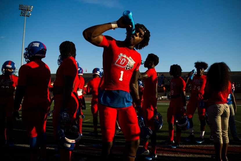 Duncanville defensive back Stacy Brown (1) drinks water during warmups before a high school...