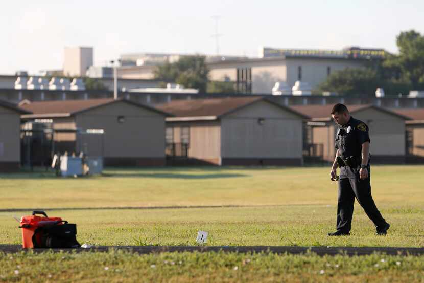 Dallas ISD police scan the track and football field where a girl was shot at Skyline High...
