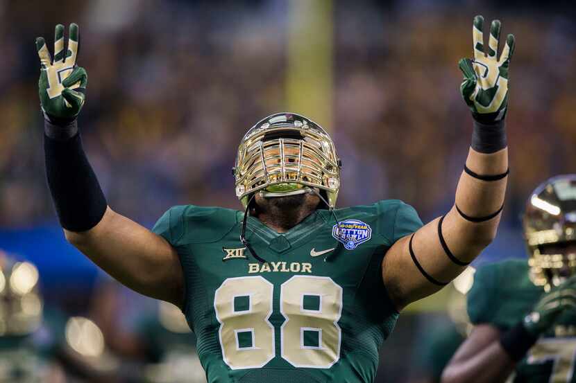 Baylor Bears defensive lineman Terell Brooks (88) signals to the crowd while running out on...