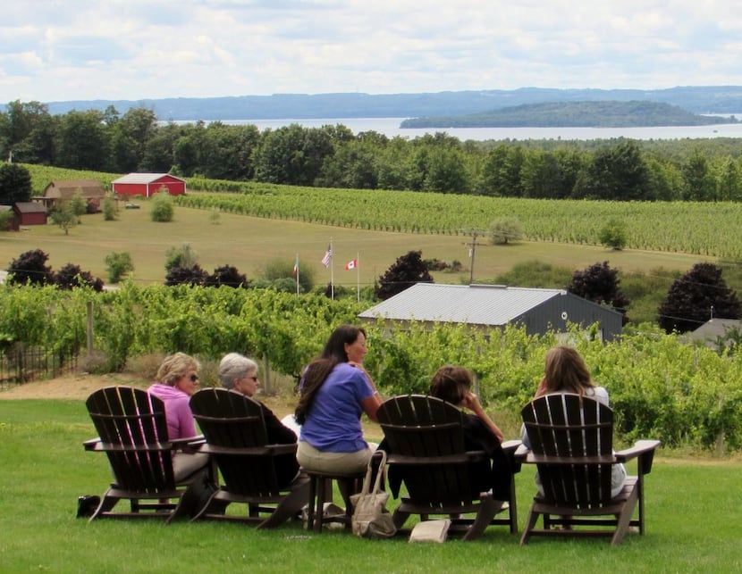 
Visitors savor the view of the vineyards and bay at Chateau Chantal Winery on the Old...