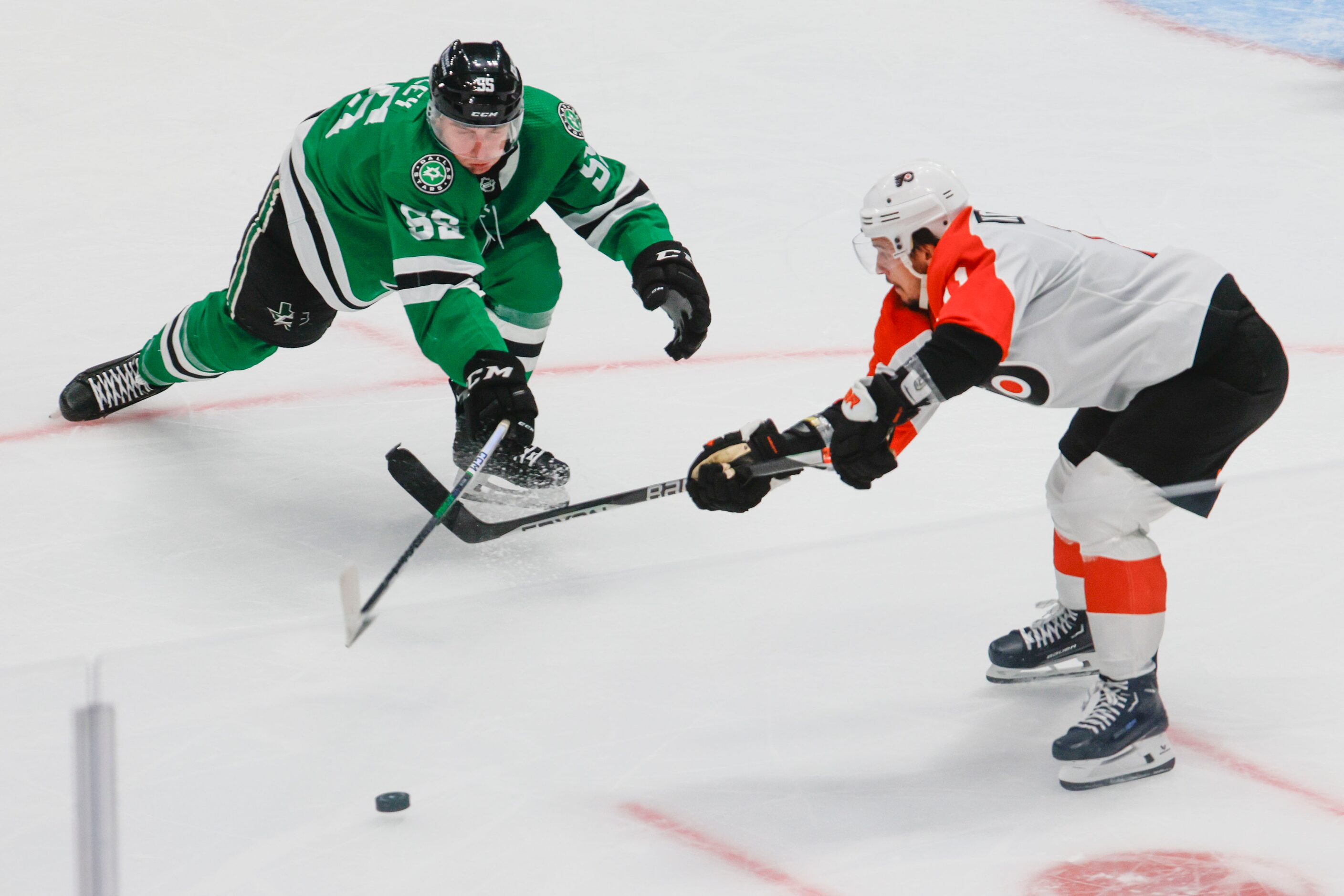 Dallas Stars defenseman Thomas Harley (left) and Philadelphia Flyers right wing Travis...