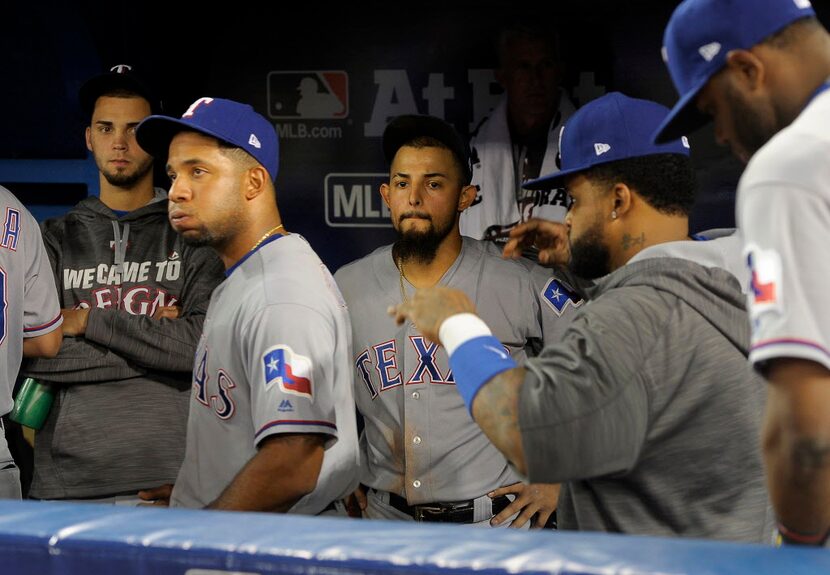 Texas Rangers relief pitcher Alex Claudio (58), shortstop Elvis Andrus (1) and second...