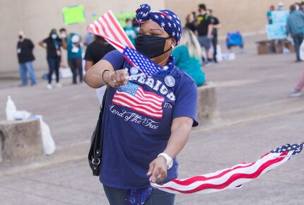 Bridge Brown of Dallas danced and waved flags in jubilation over Biden's victory during the...