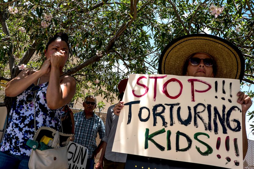 Viridiana Gonzalez, 35, left, and Yvonne Nieves, 55, both of El Paso, demonstrate outside a...