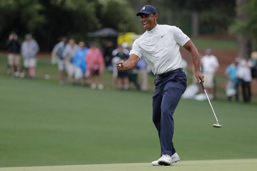 Tiger Woods reacts to his birdie putt on the 15th hole during the second round for the...