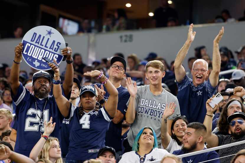 Dallas Cowboys fans celebrate in the second half of a preseason NFL football game against...