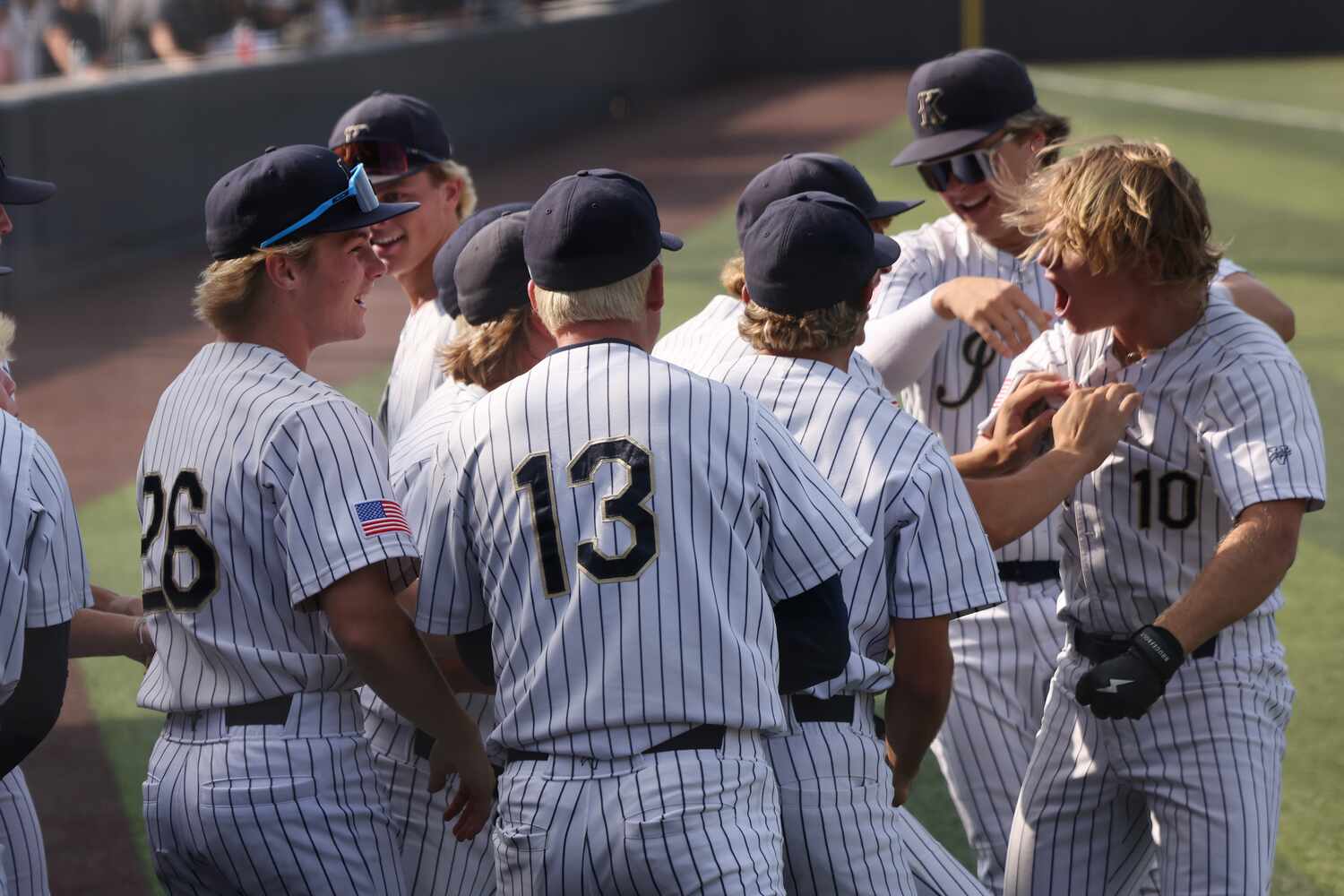 Keller designated hitter Drew Roberts (10), far right, lets out a yell as he is greeted by...