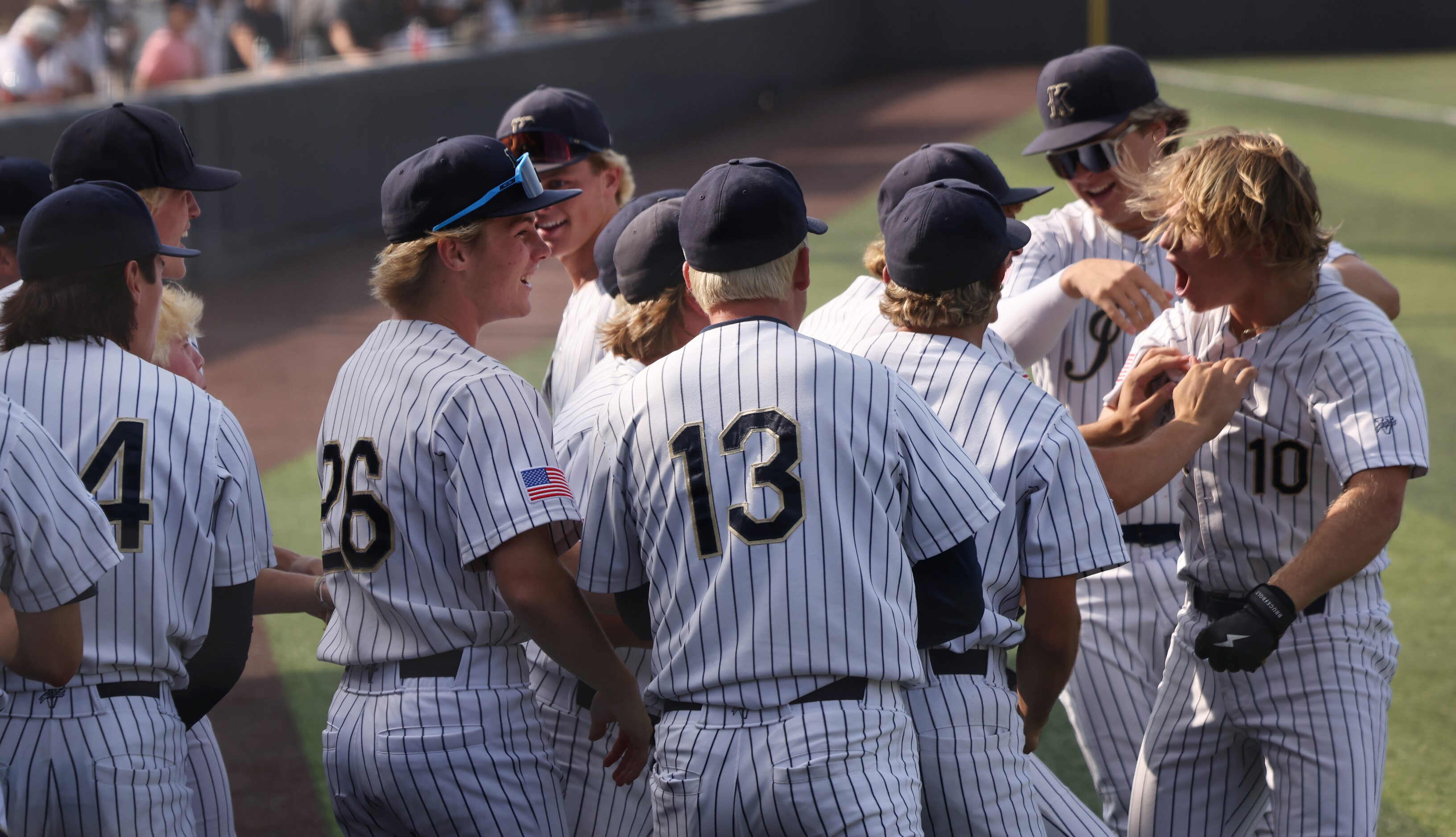 Keller designated hitter Drew Roberts (10), far right, lets out a yell as he is greeted by...