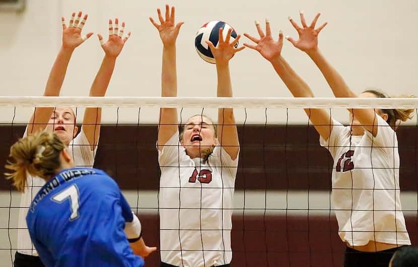 Plano West High School Jill Pressly (7) hits the volleyball past Plano Senior High...