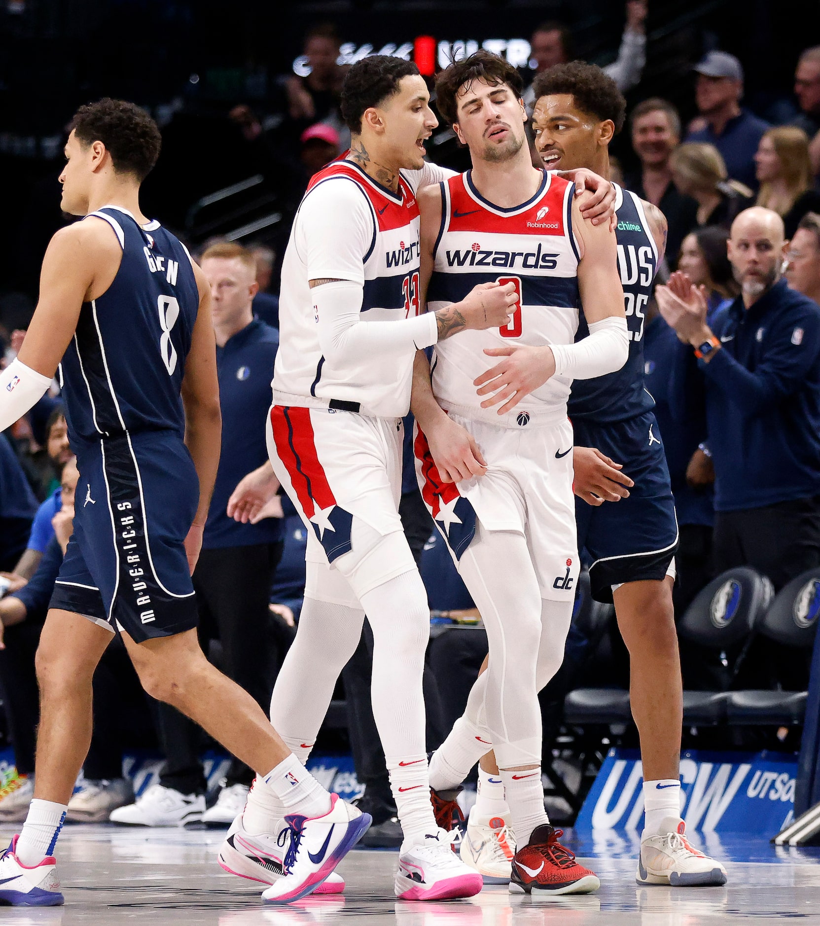 Washington Wizards forward Kyle Kuzma (33) walks Washington Wizards forward Deni Avdija (8)...